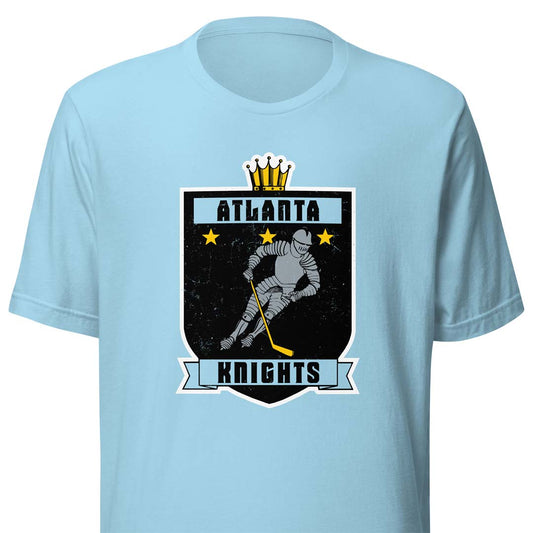 A light blue short-sleeve t-shirt with a graphic on the chest featuring a hockey player in a black shield with the text 'ATLANTA KNIGHTS' and a gold crown above.