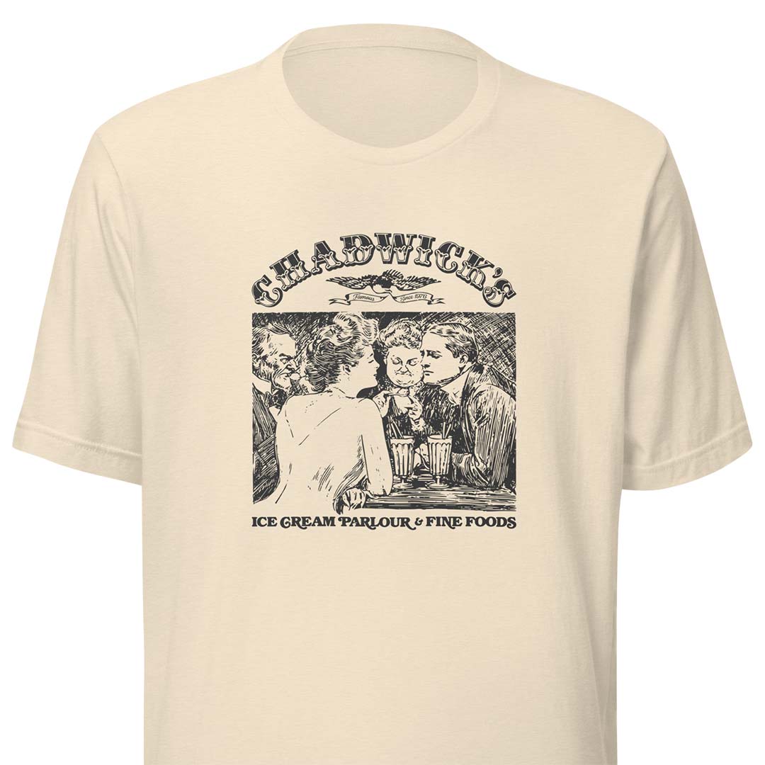 A cream-colored short-sleeve t-shirt with a black graphic print on the front. The graphic features the text 'CHADWICK'S' above an illustration of people eating ice cream, with 'ICE CREAM PARLOUR & FINE FOODS' printed below.