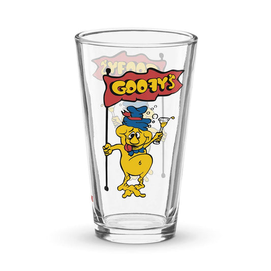 A clear glass pint-style drinking glass featuring a colorful retro print of the Goofy character holding a flag that reads 'GOOFY'S' on a white background.