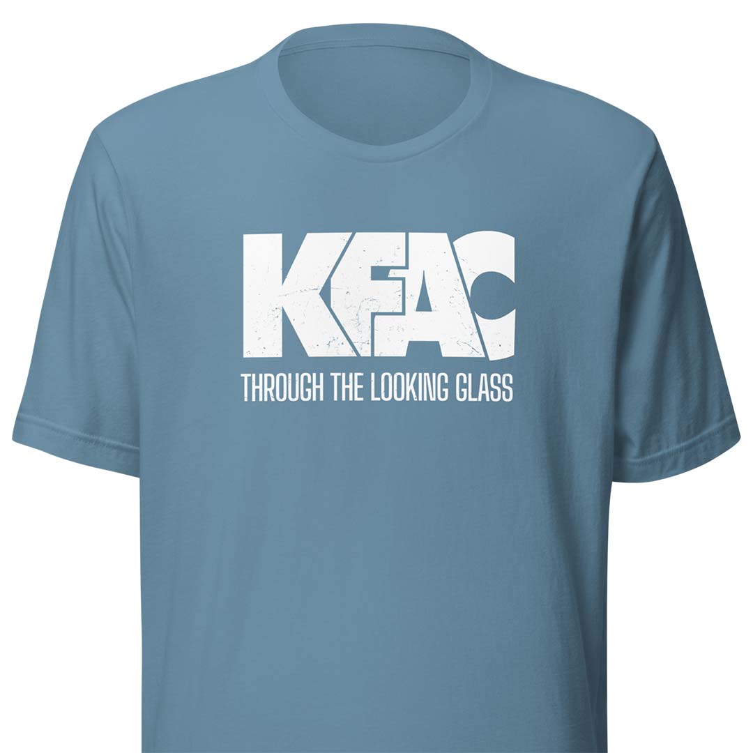 A dusty blue short-sleeve t-shirt with a white distressed graphic on the chest reading 'KFAC' and 'THROUGH THE LOOKING CLASS'.