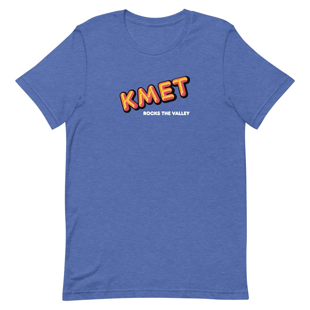 A heather blue short-sleeve t-shirt with a graphic on the chest reading 'KMET' in orange and yellow with a black outline, and 'ROCKS THE VALLEY' in white underneath, shown on a plain white background.