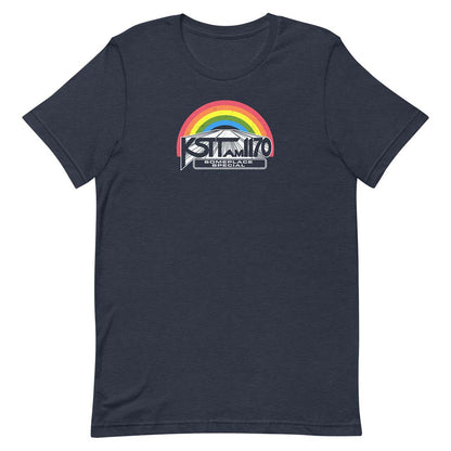 A navy blue short-sleeve t-shirt with a graphic on the chest featuring a rainbow arch over a mountain and the text 'KSTT AM 1170' and 'SOMEPLACE SPECIAL'.