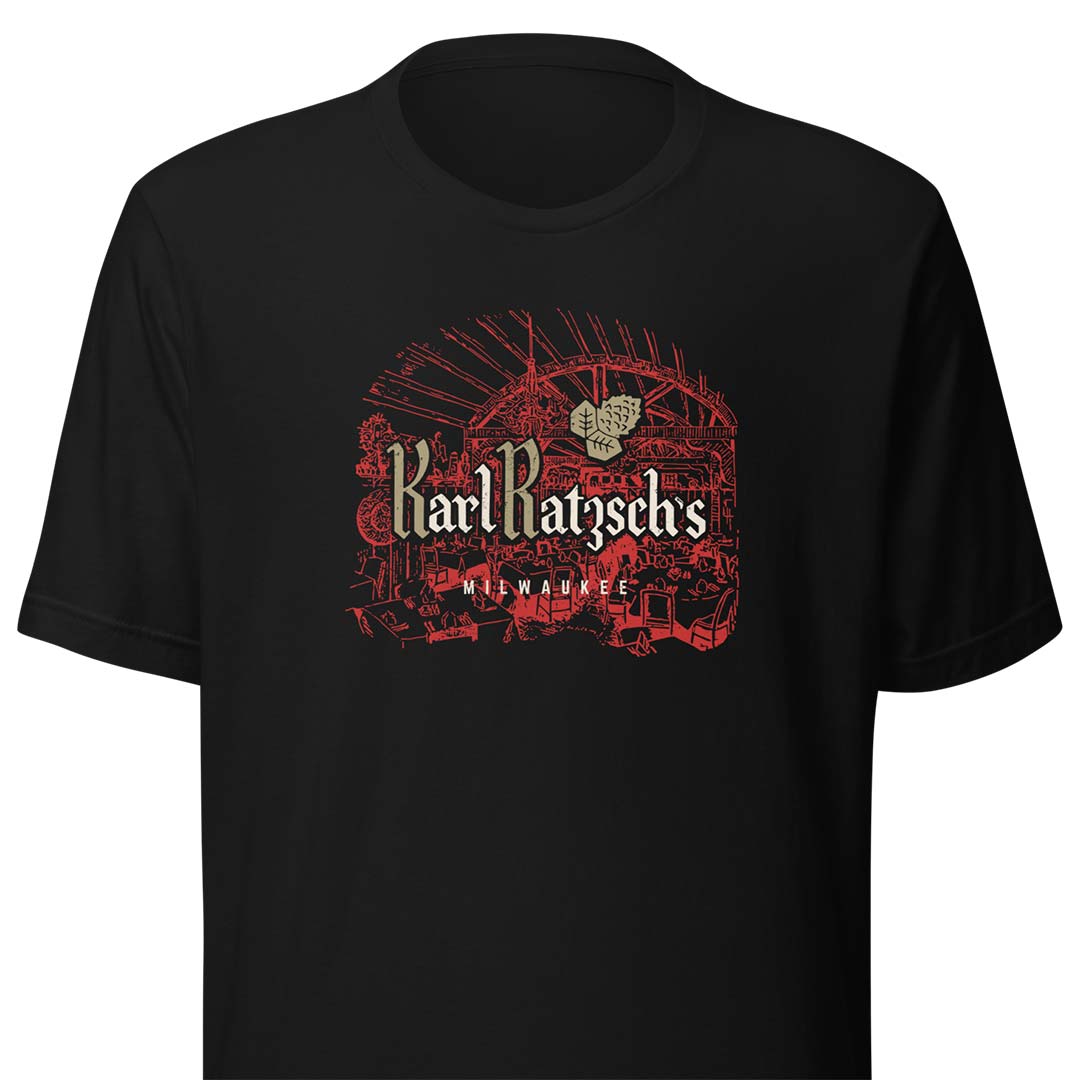 A black short-sleeve crewneck t-shirt featuring a vintage-style graphic of a beer glass in red, with the text 'Karl Ratysch's' and 'Munich' in beige and red.