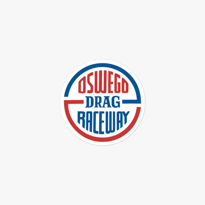 A circular sticker or decal featuring the text 'OSWEGO DRAG RACEWAY' in red and blue lettering, centered on a light gray background.