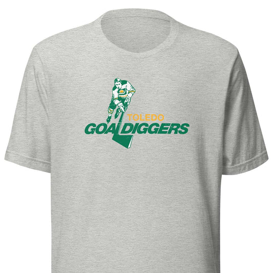 A heather gray short-sleeve crewneck t-shirt featuring a 'Toledo Goal Diggers' graphic on the chest with a football player and a green map outline.
