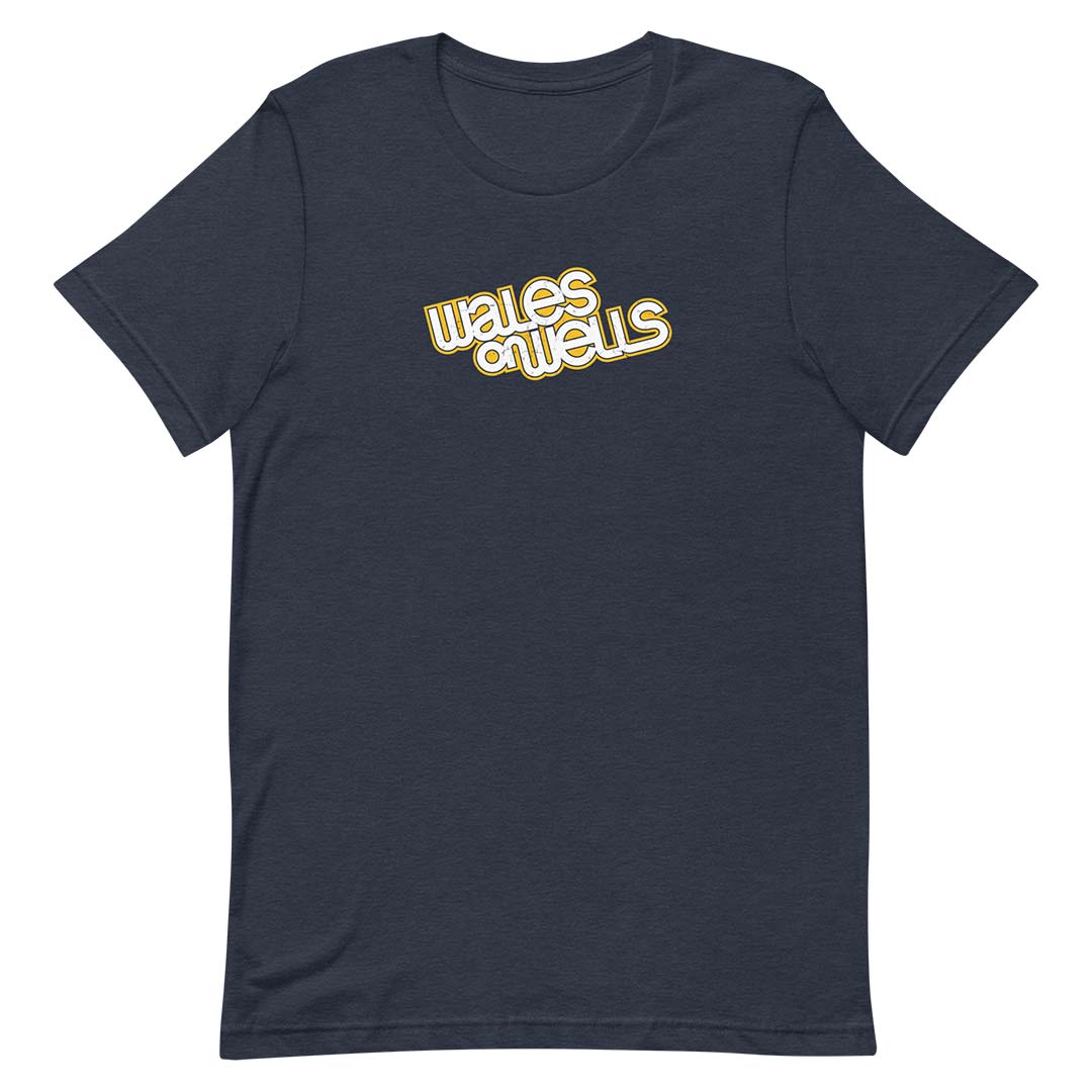 A dark navy blue short-sleeve t-shirt with a retro-style graphic on the chest reading 'wales on wells' in yellow with a white outline, displayed on a solid white background.