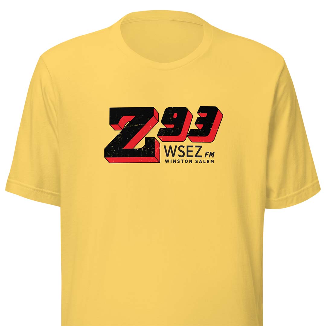 A yellow short-sleeve crewneck t-shirt featuring a large 'Z93 WSEZ FM Winston Salem' graphic printed on the chest in black and red.
