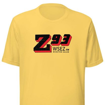 A yellow short-sleeve crewneck t-shirt featuring a large 'Z93 WSEZ FM Winston Salem' graphic printed on the chest in black and red.
